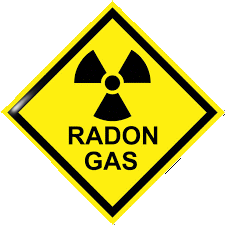 Radon gas written on yellow diamond sign with radioactive symbol.